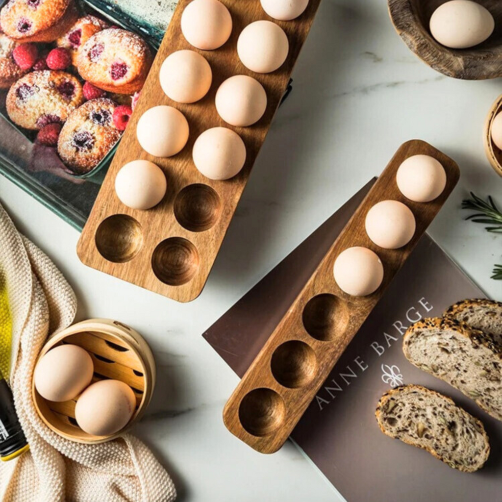 Two-wooden-egg-trays-with-capacity holes-filled-with-eggs-displayed-on-a-white-background