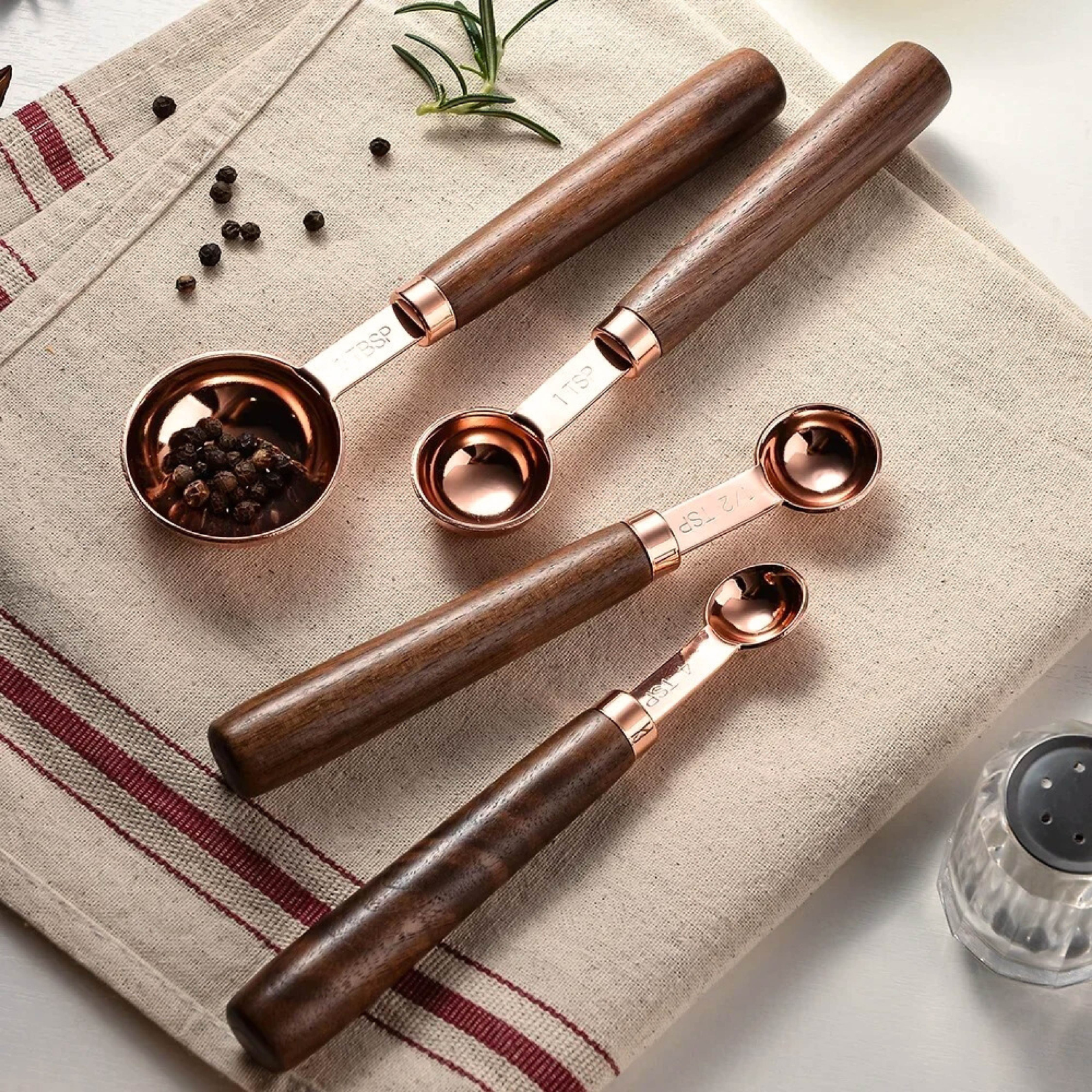 Rose measuring spoons arranged together as a styled kitchen accessory set