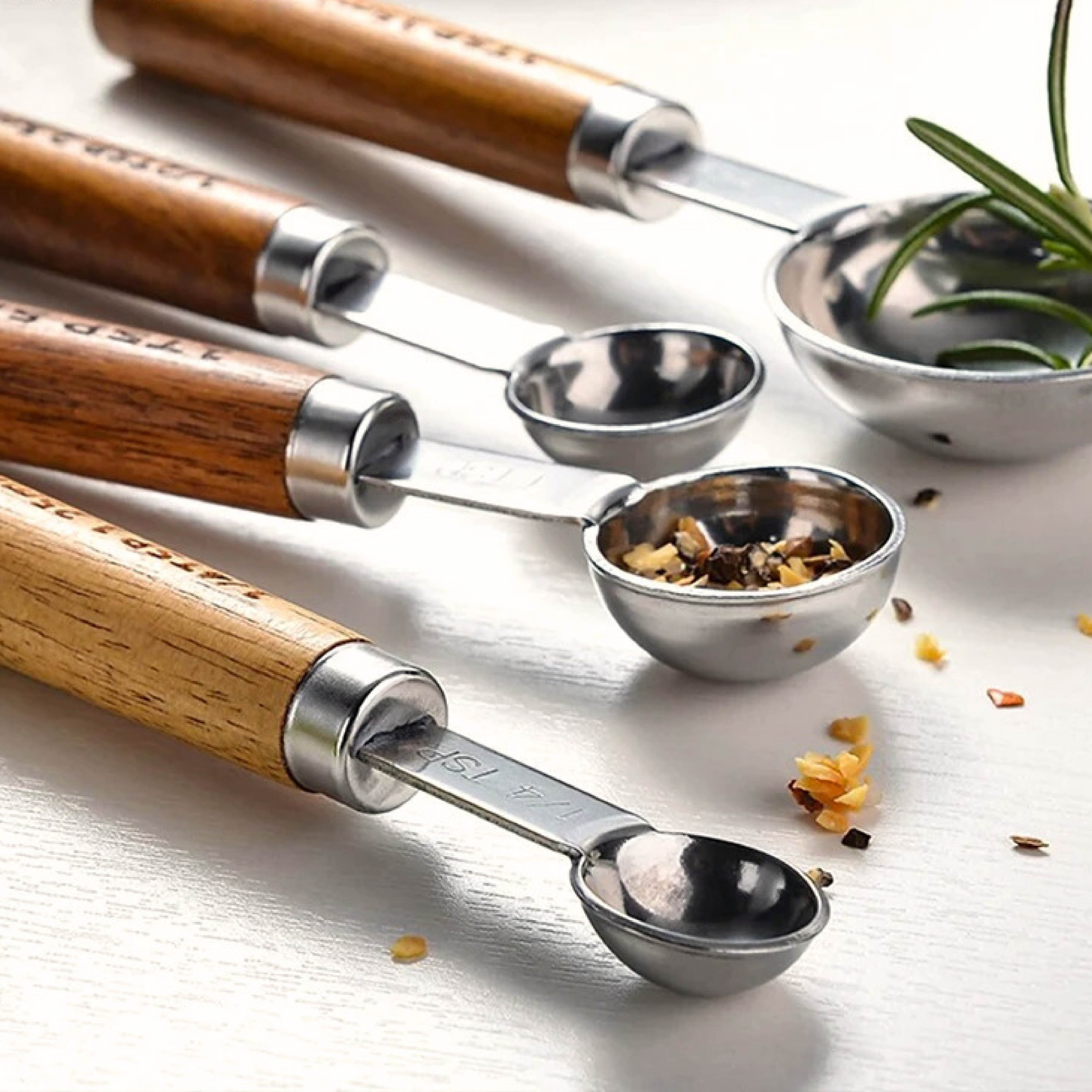 Silver measuring spoons arranged together as a styled kitchen accessory set