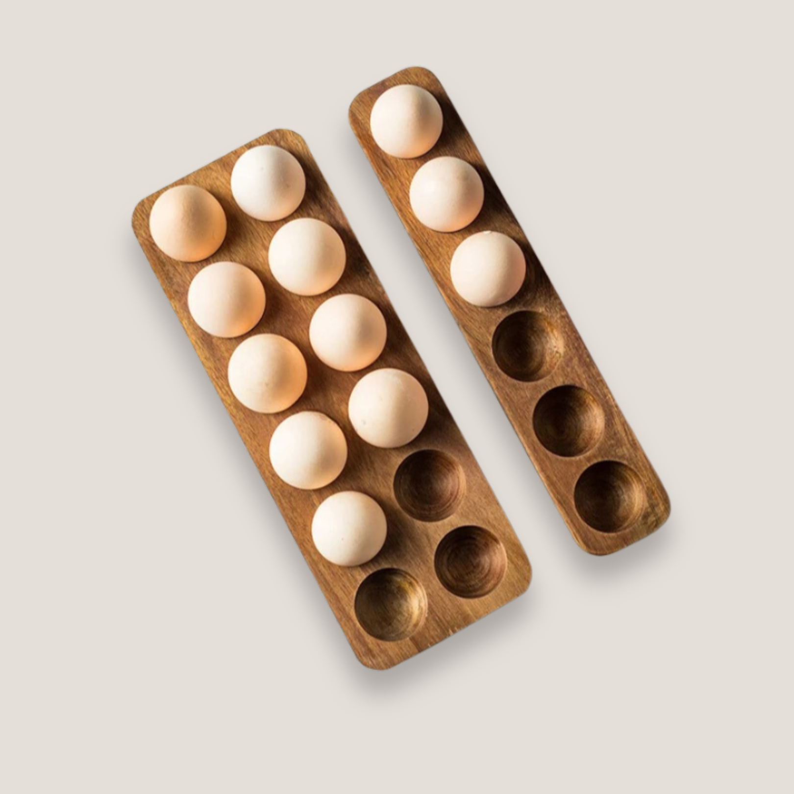 Two-wooden-egg-trays-with-capacity holes-filled-with-eggs-displayed-on-a-white-background