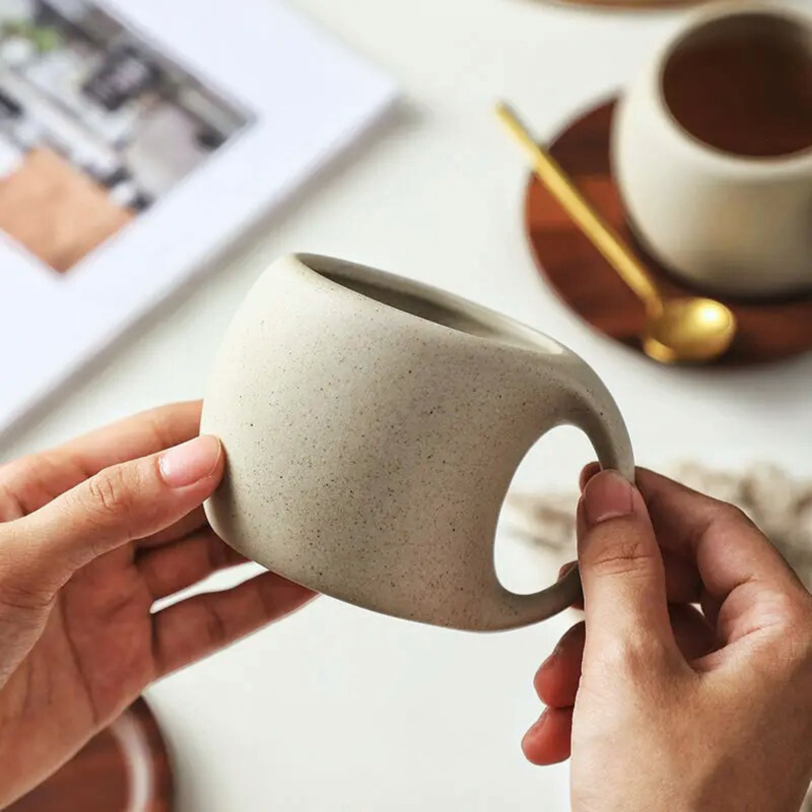  Hand holding the ceramic cup to show size and grip