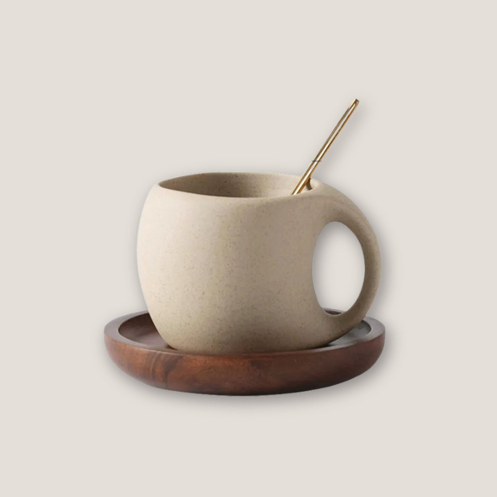 Ceramic cup with stainless steel spoon placed on a round wooden base, styled on light background