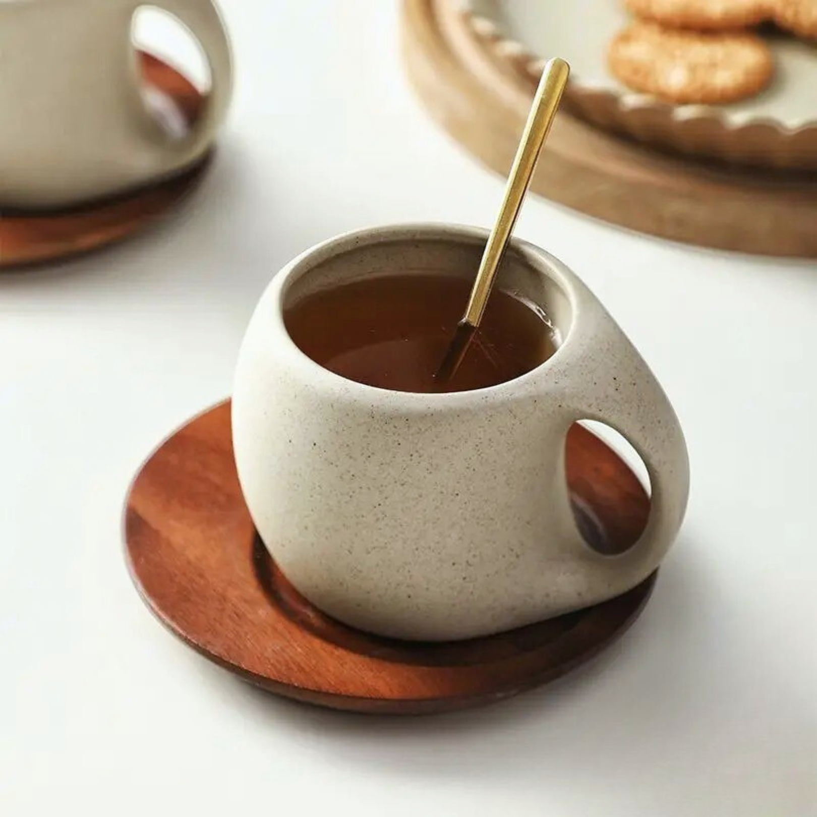 Cup, spoon, and base arranged together as an elegant set displayed from slight angle