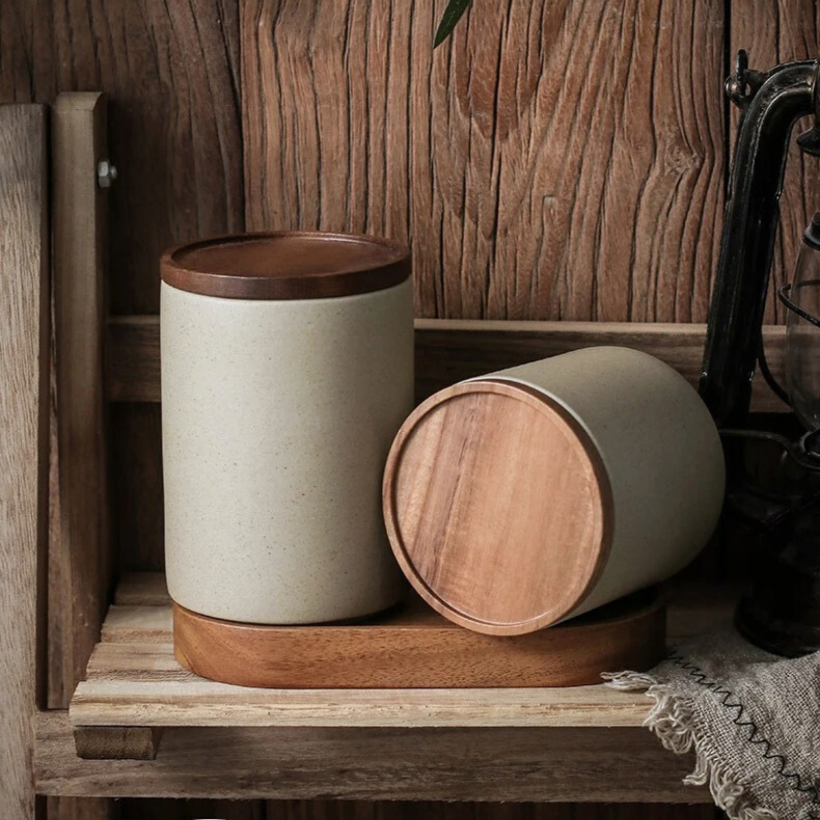 Ceramic storage jar lying horizontally on its side with wooden lid attached
