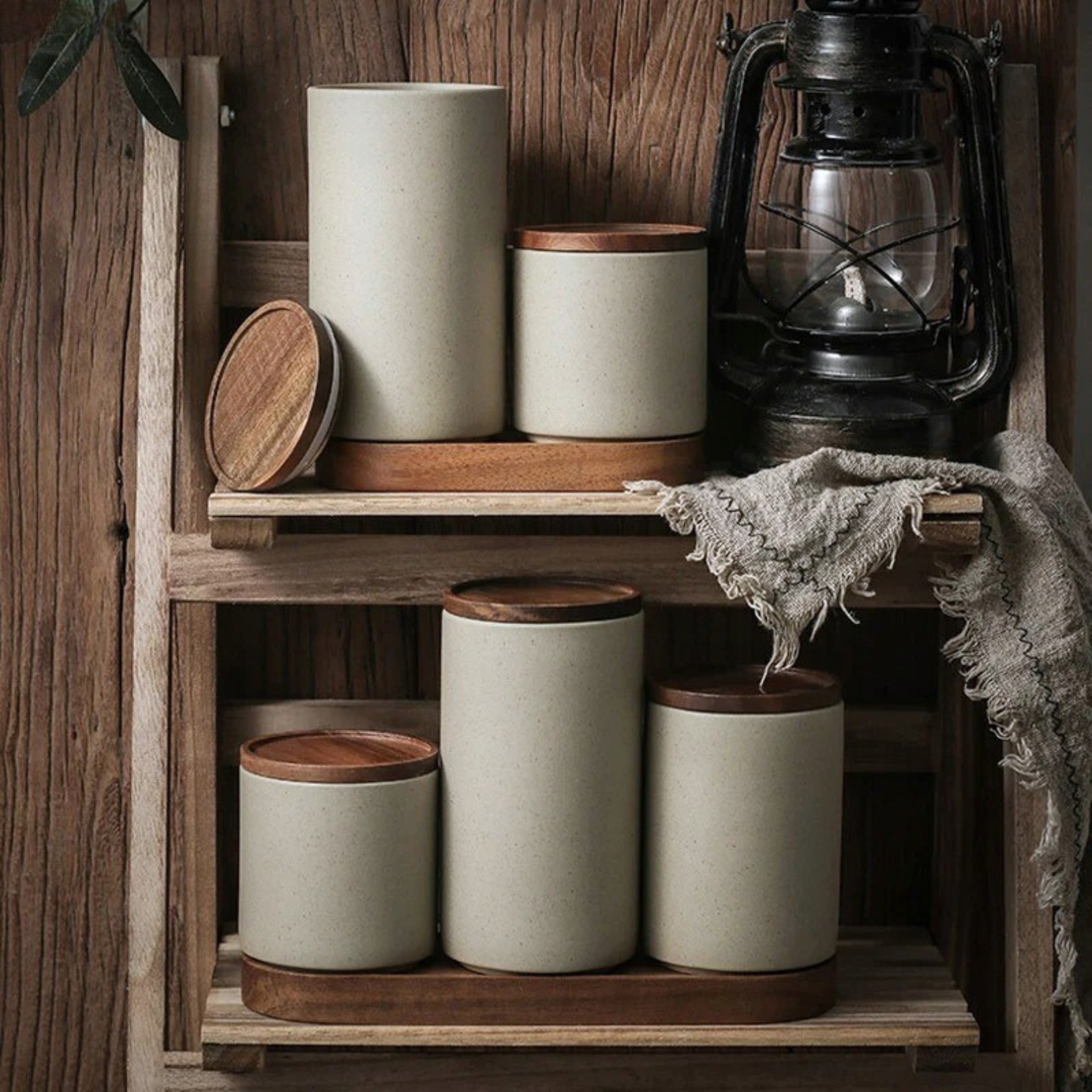 Ceramic storage jar with wooden lid displayed neatly on a kitchen pantry shelf