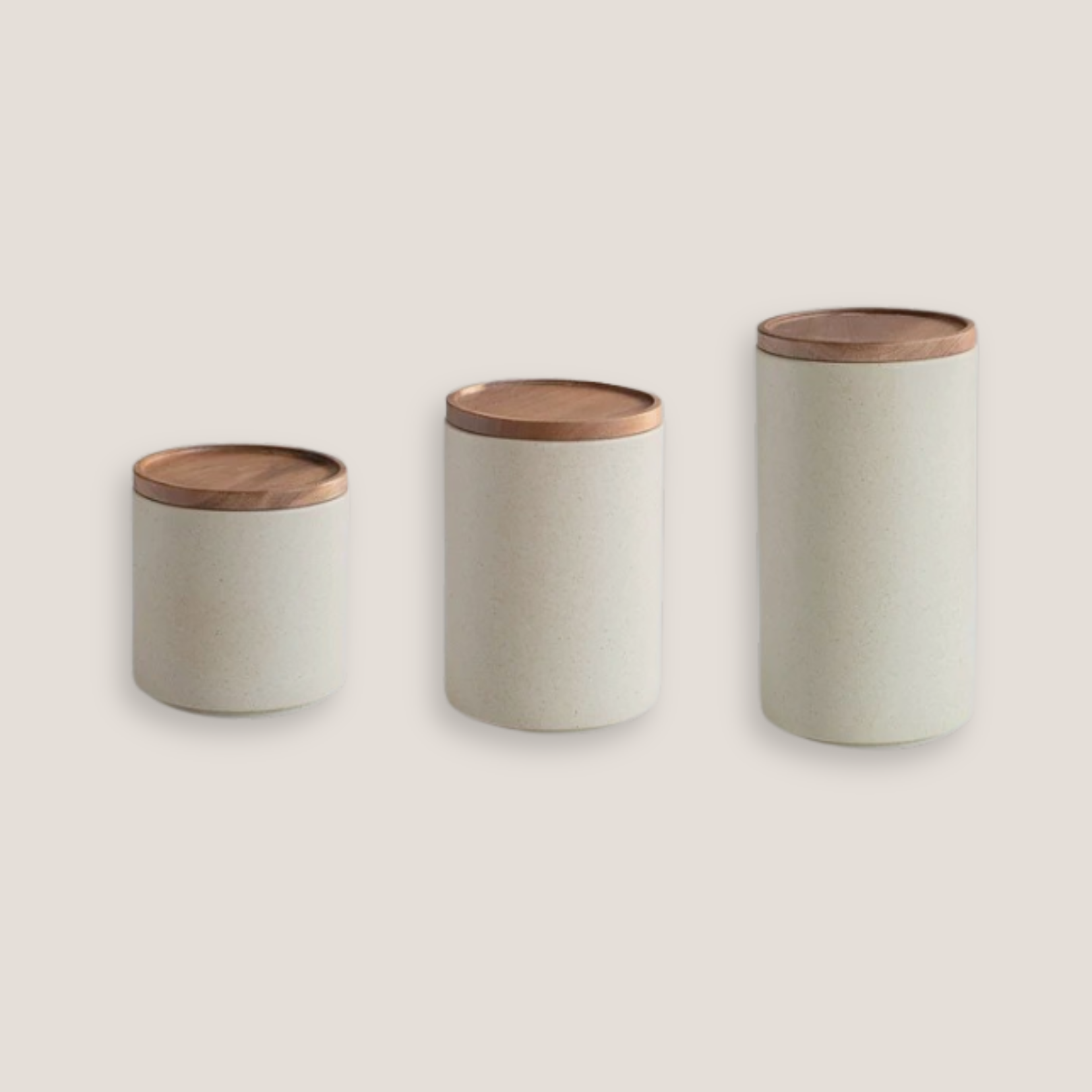 Three different white ceramic storage jar with natural wooden lid, shown sealed against neutral background