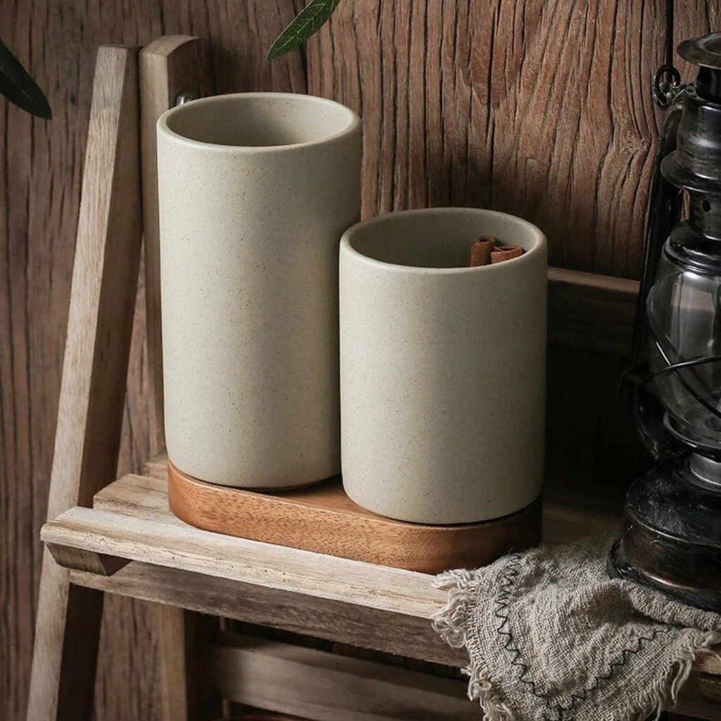 Ceramic storage jars with wooden lids off, neatly arranged on a pantry shelf, showing open tops