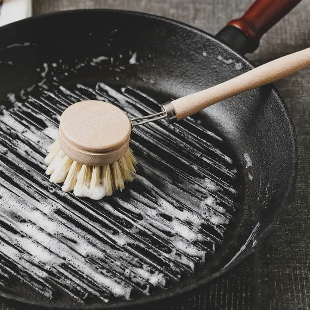 Eco-friendly sisal brush in action on nonstick cookware