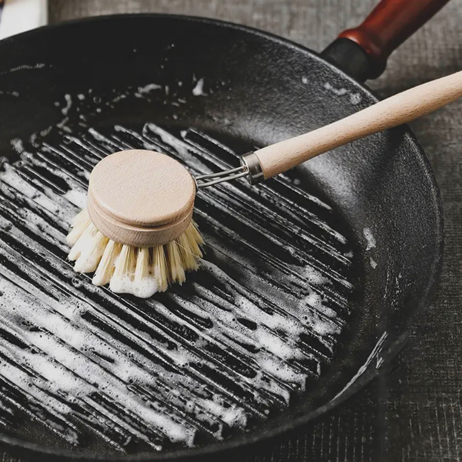 Eco-friendly sisal brush in action on nonstick cookware