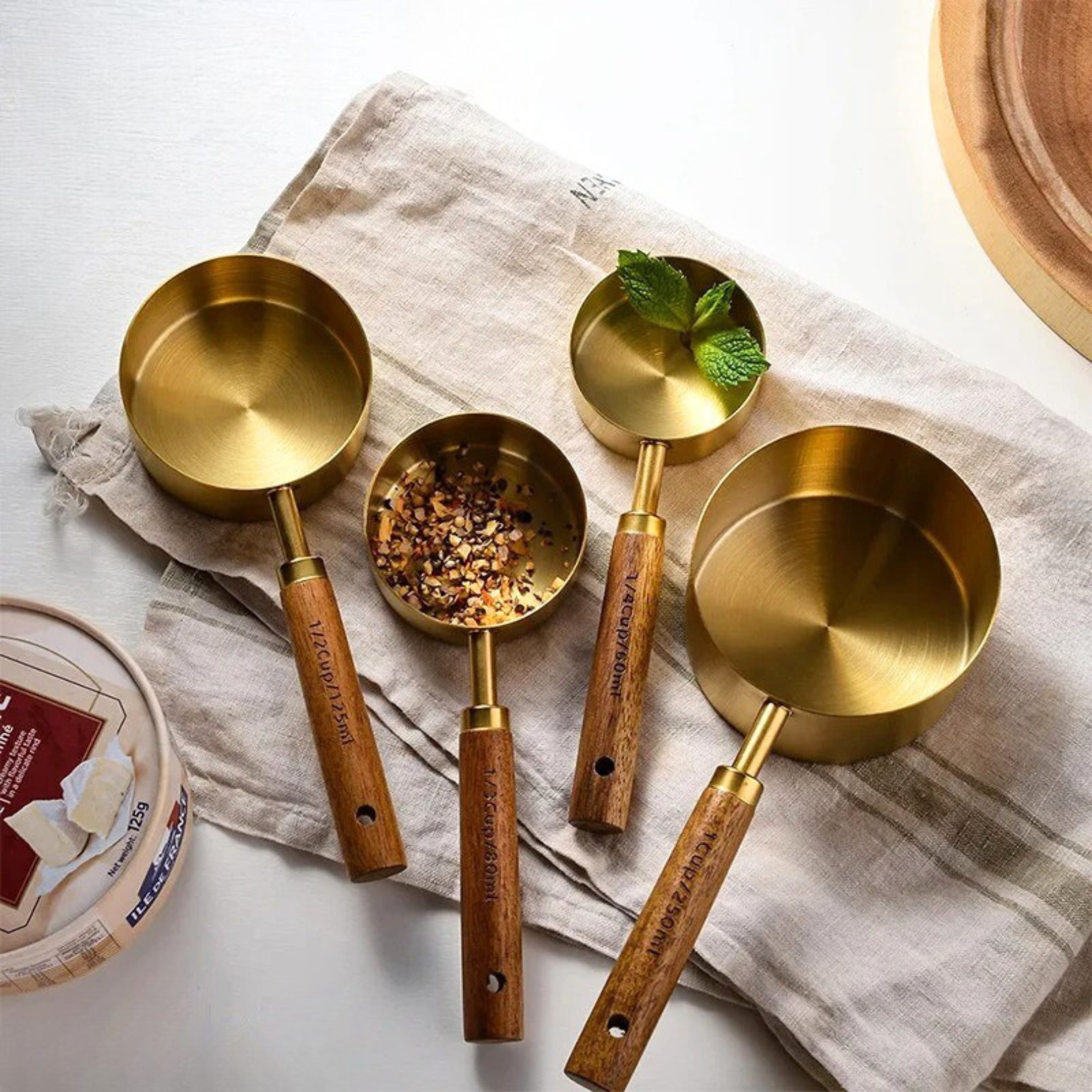 Gold measuring cups arranged together as a styled kitchen accessory set