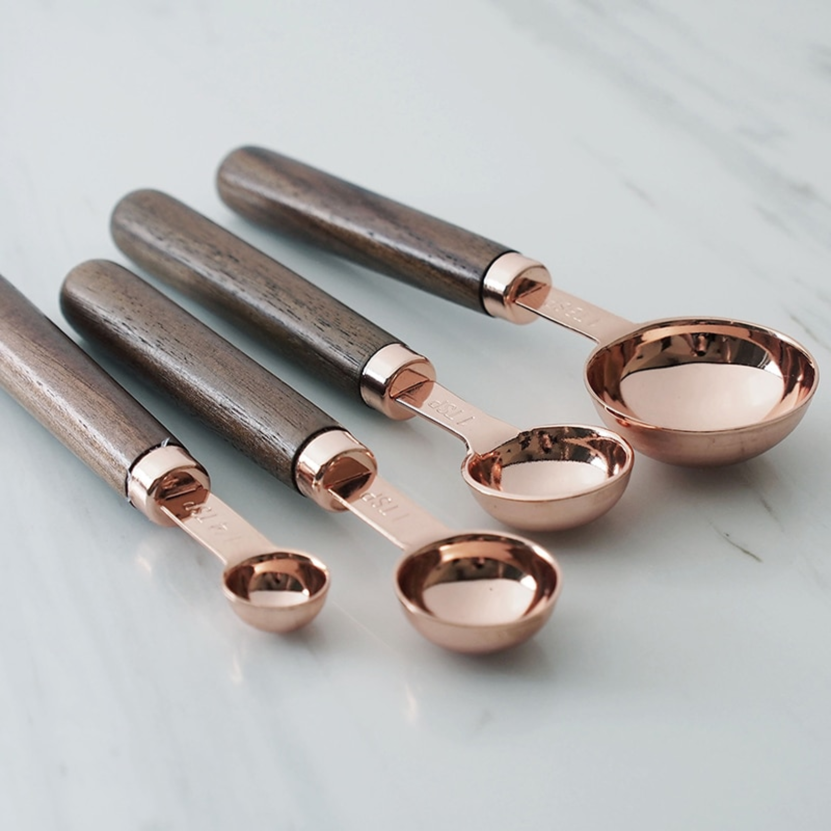 Close-up of a rose measuring spoons focusing on the metal bowl