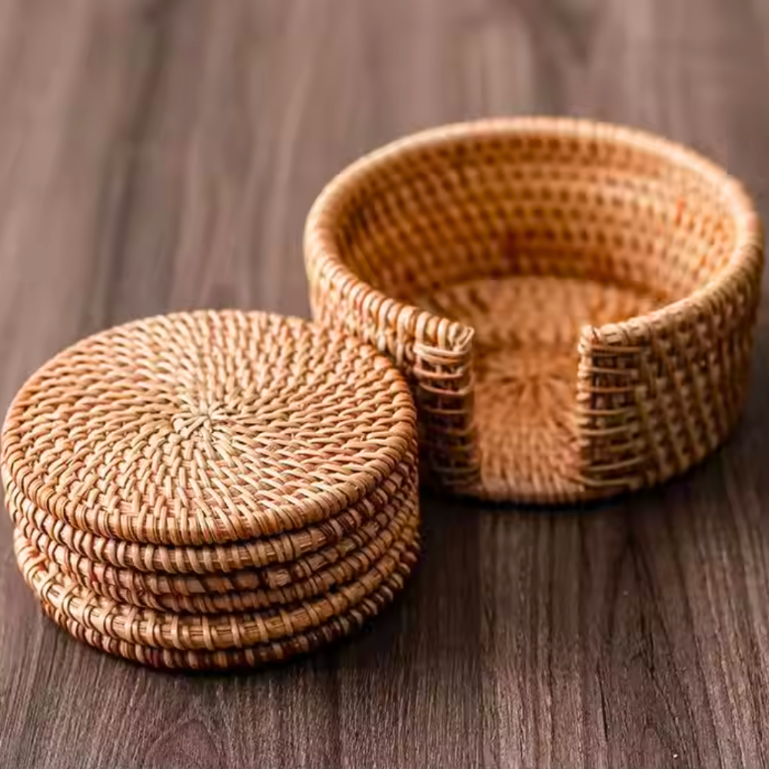 Single rattan coaster placed on a rustic brown wooden table, with the empty coaster holder displayed beside it for storage context