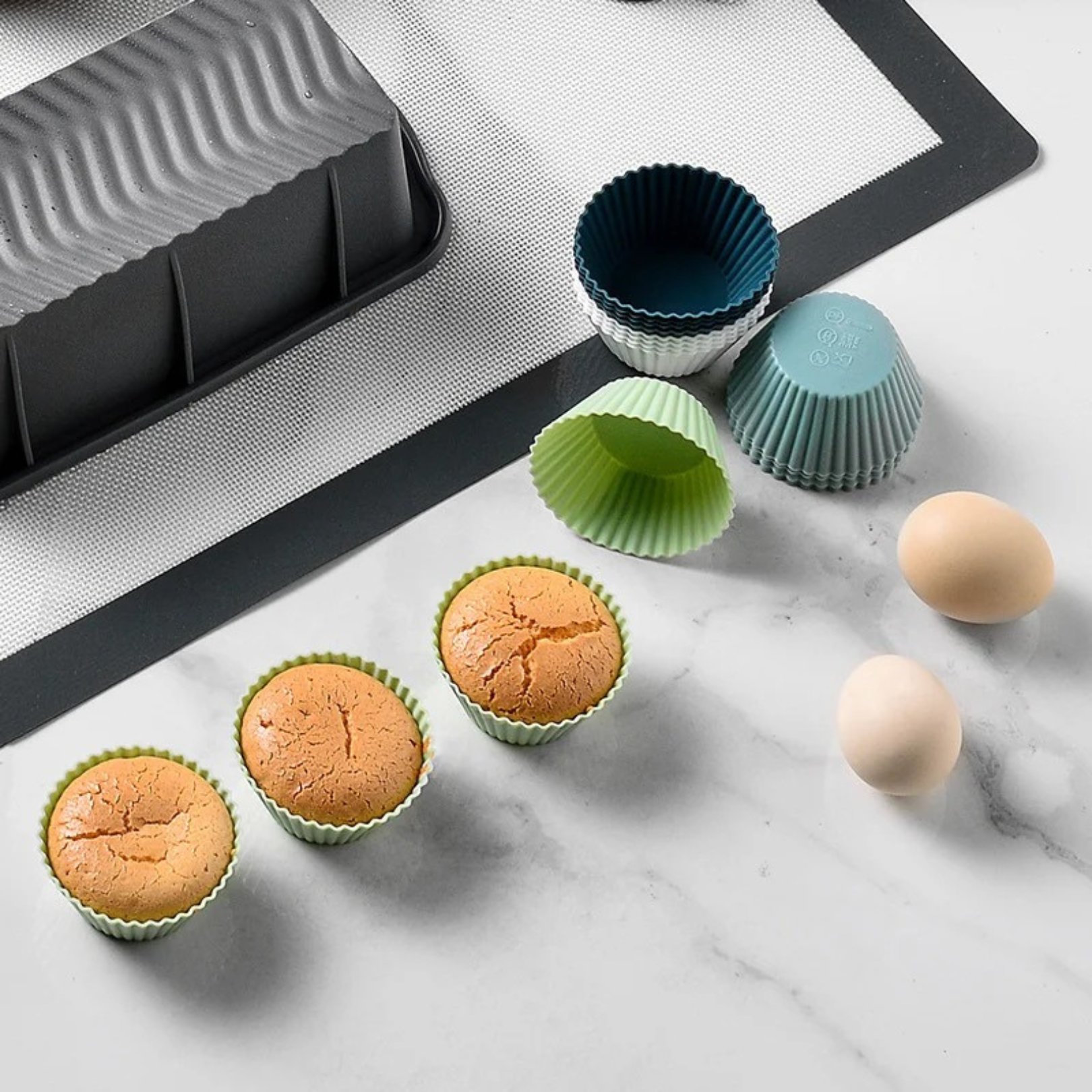 Silicone muffin baking cups on a kitchen table with two eggs beside them, creating a cozy baking scene