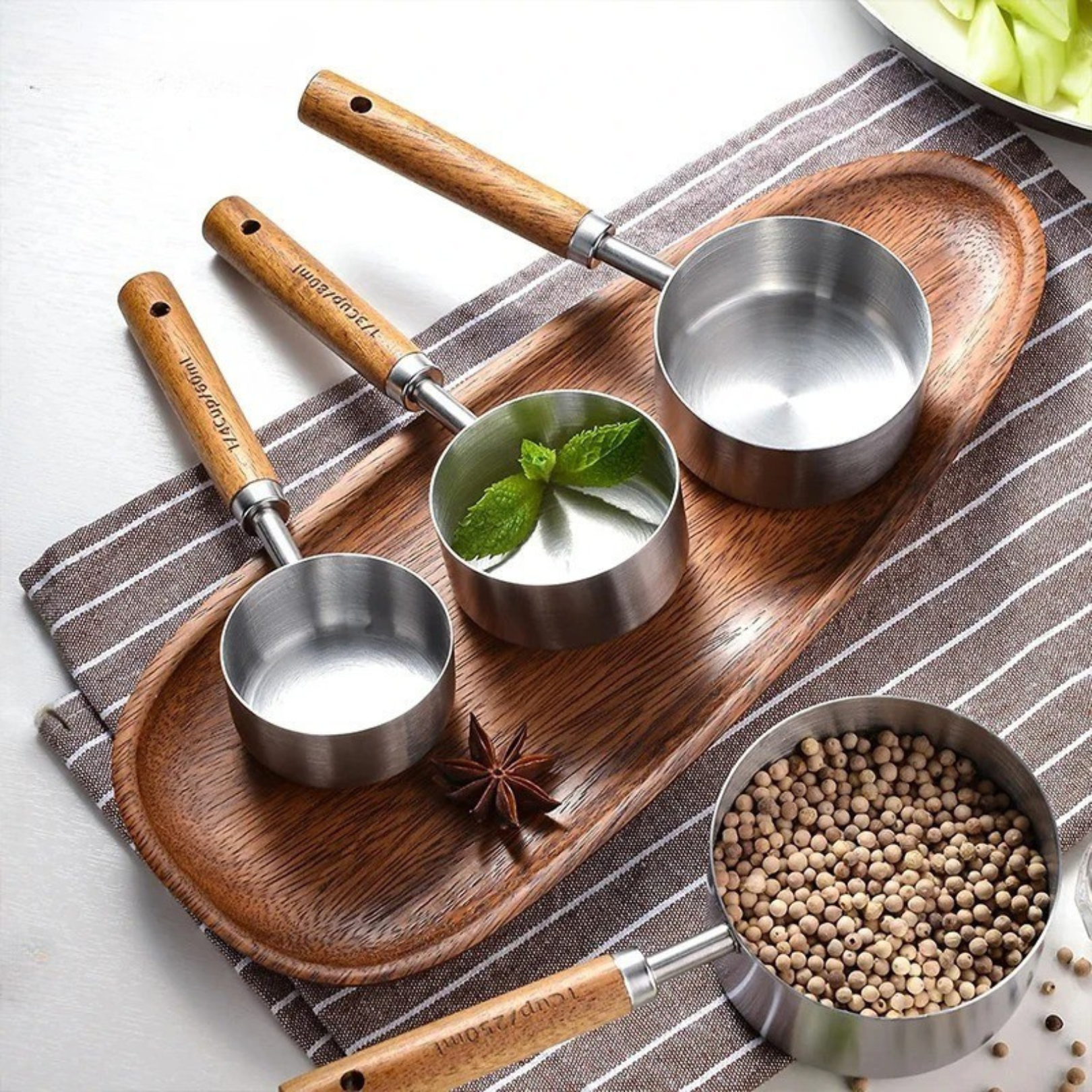 Silver measuring cups arranged together as a styled kitchen accessory set