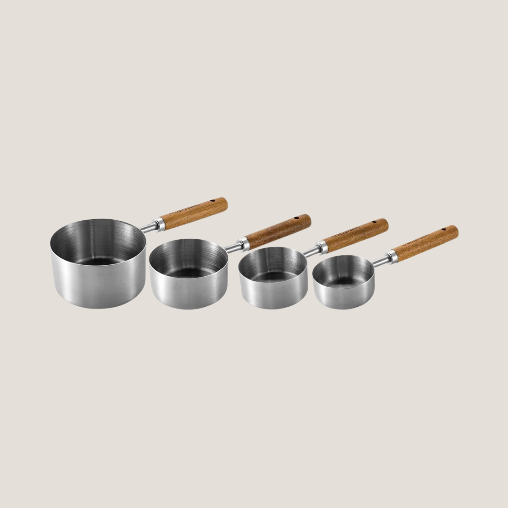 Set of silver measuring cups arranged in order from largest to smallest, neatly fanned out to show size variation