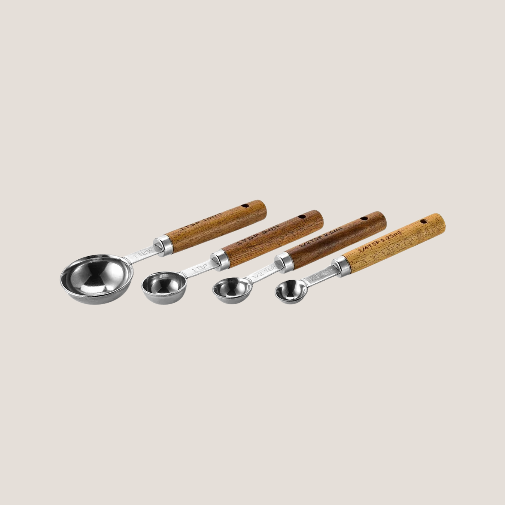 Set of silver measuring spoons arranged in order from largest to smallest, neatly fanned out to show size variation