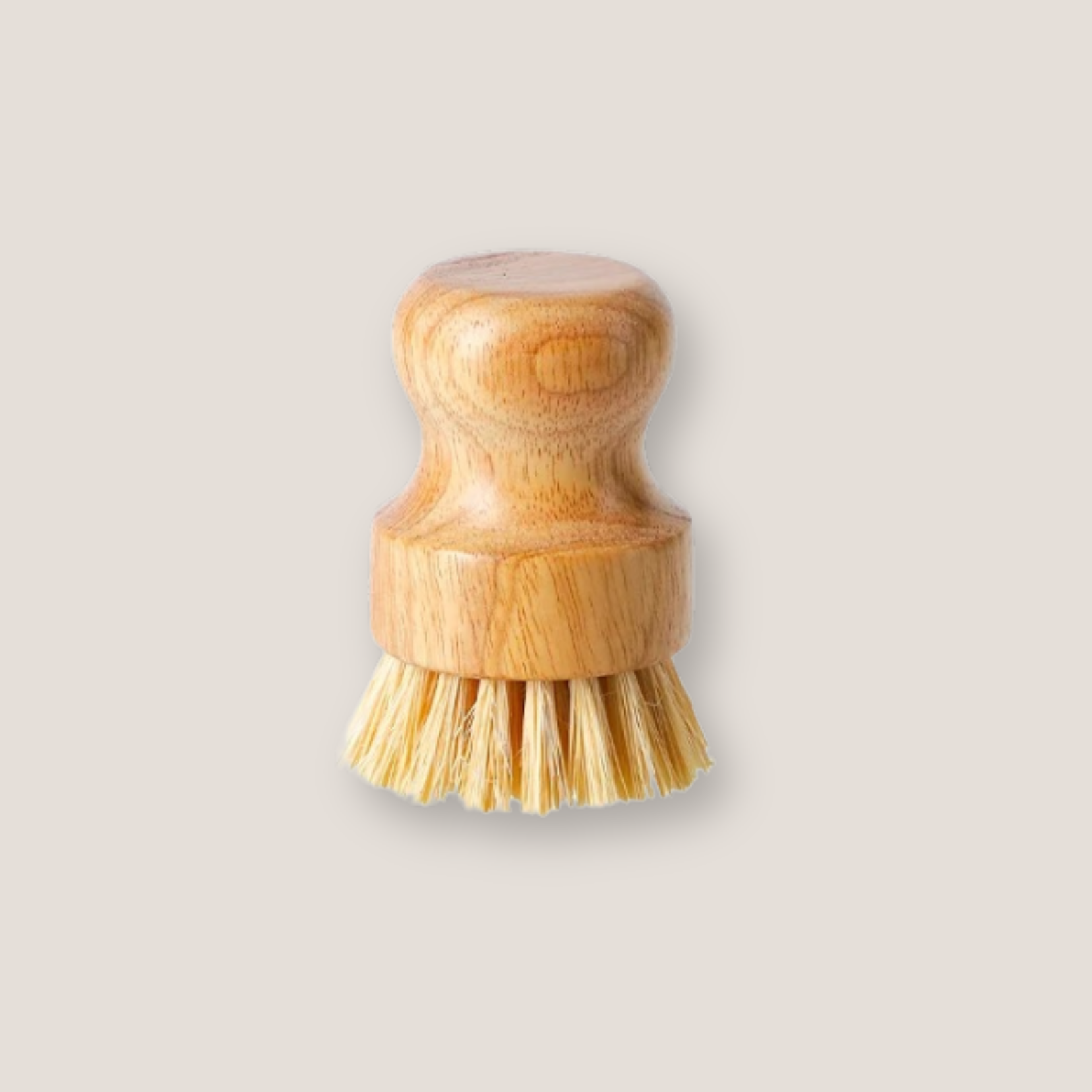Sisal fiber scrubber resting on its bristles, with the wooden handle clearly visible