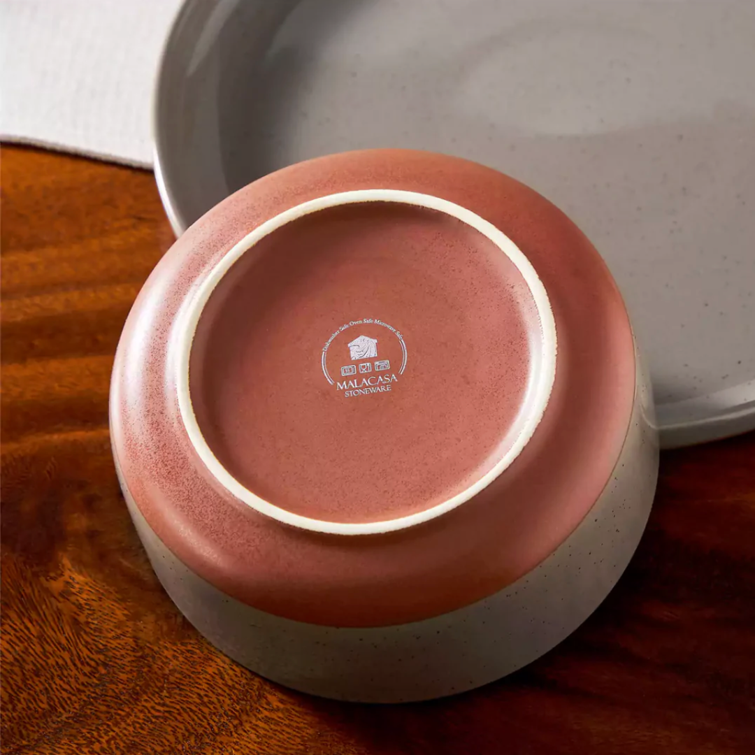 Rear view of an earthy brown stoneware bowl highlighting its smooth curved shape and matte finish