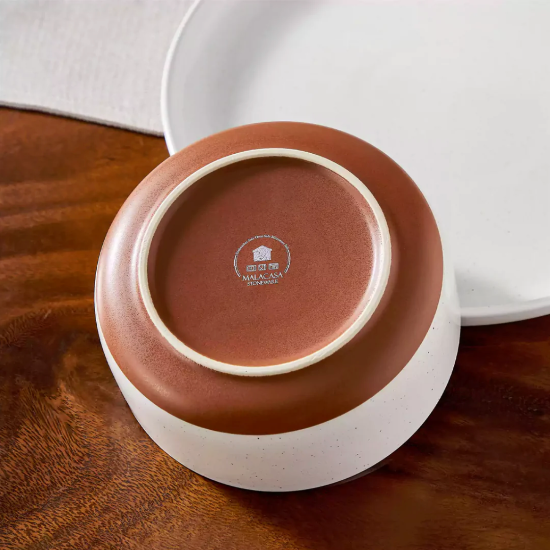 Rear view of an ivory-white stoneware bowl highlighting its smooth curved shape and matte finish