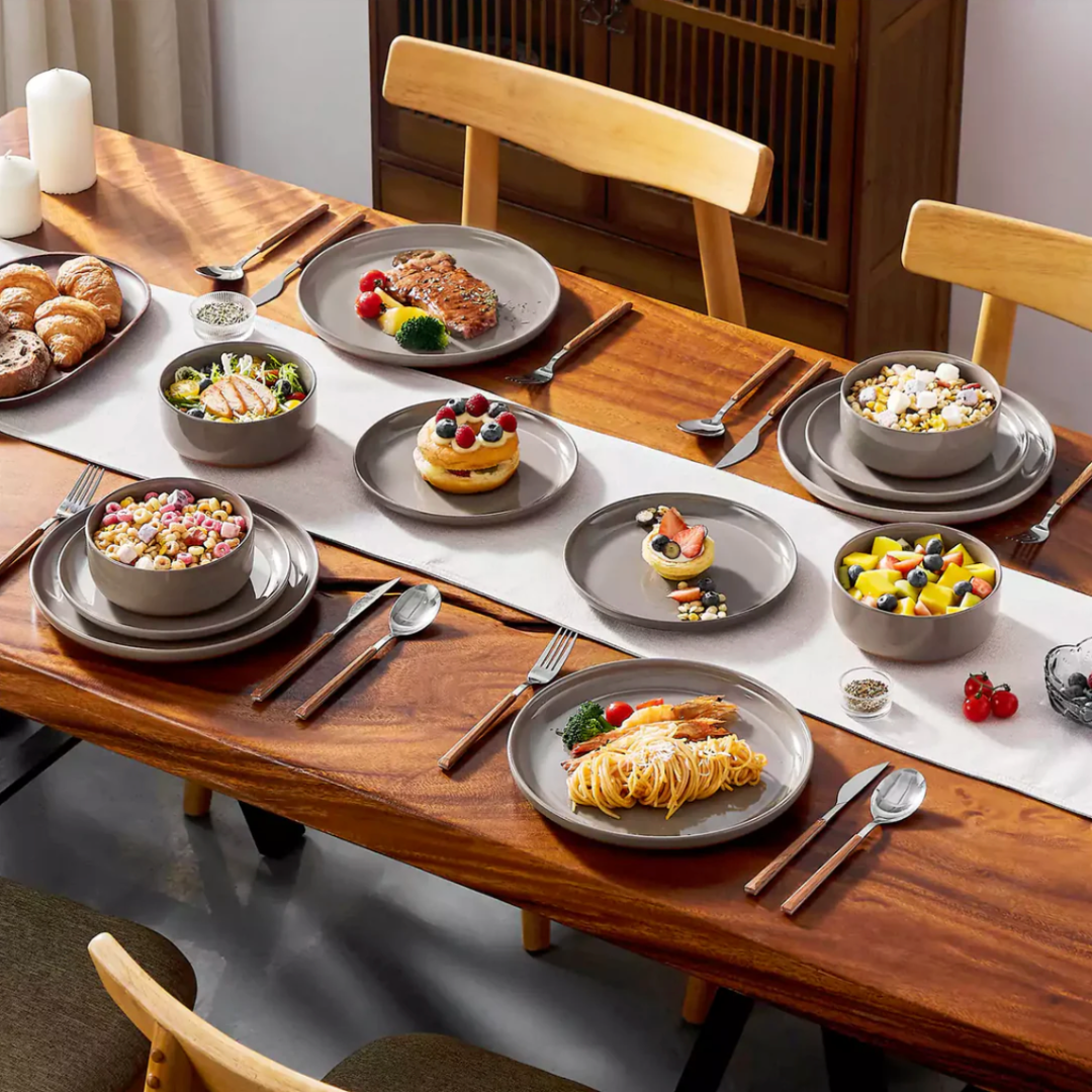 Earthy brown stoneware dining set with food served in the soup bowl, dessert plate, and dinner plate on a styled dining table