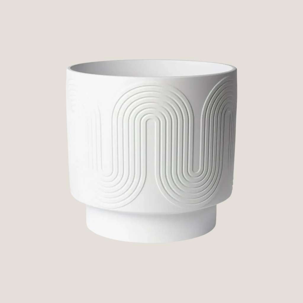 Empty white ceramic planter with textured finish, shown on neutral background
