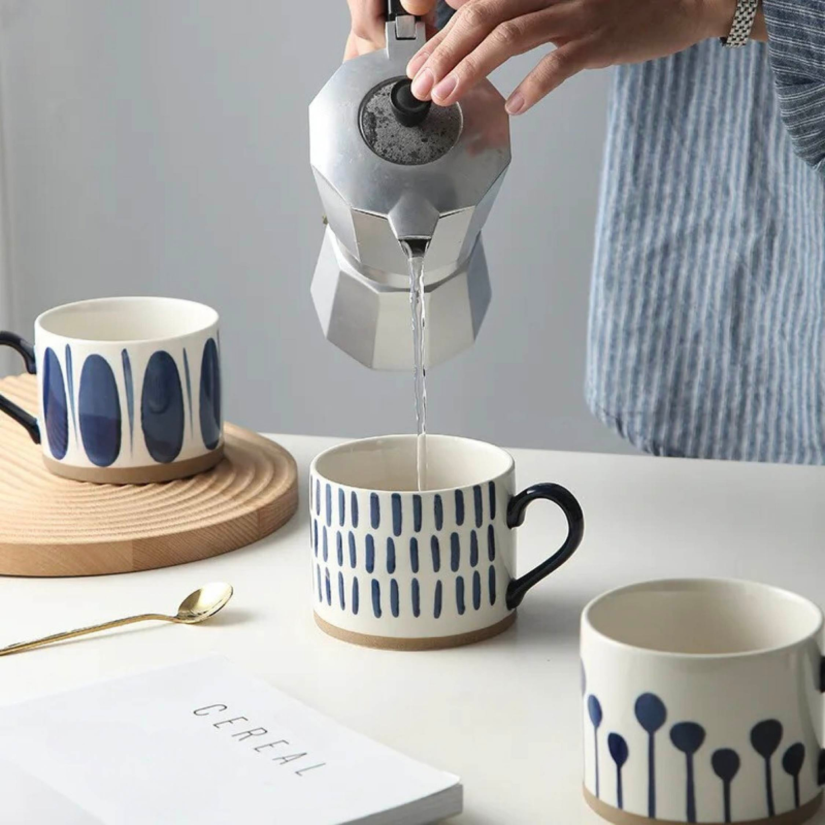 Woman pouring hot coffee into a ceramic artisan mug, capturing a warm and inviting moment.