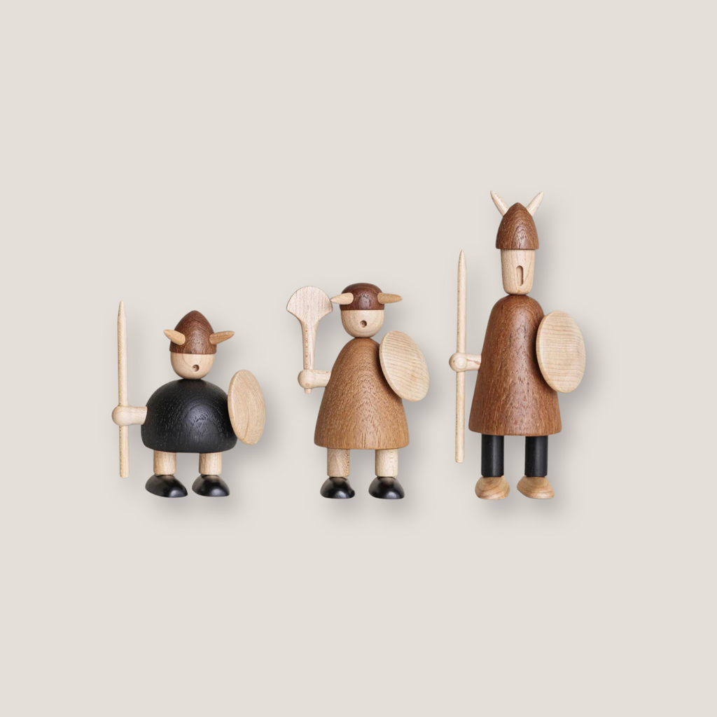 Set of three hand-carved wooden Viking figurines displayed side by side