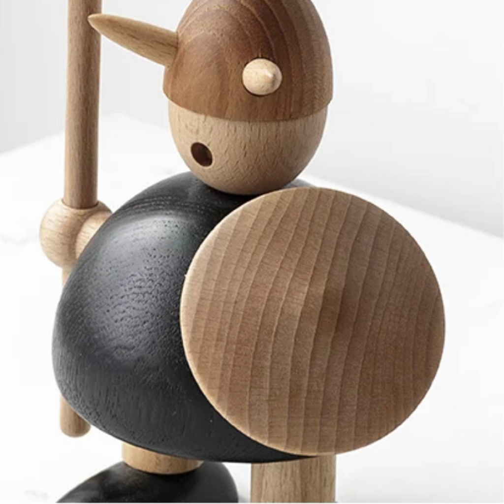 Close-up of wooden Viking figurine highlighting natural wood grain and carving details