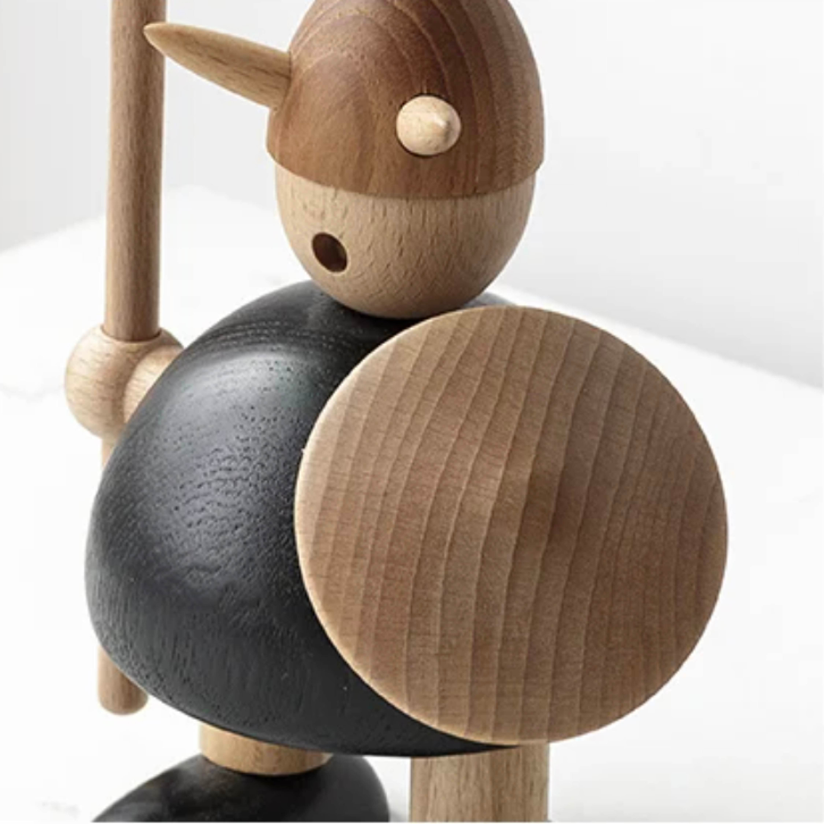 Close-up of wooden Viking figurine highlighting natural wood grain and carving details