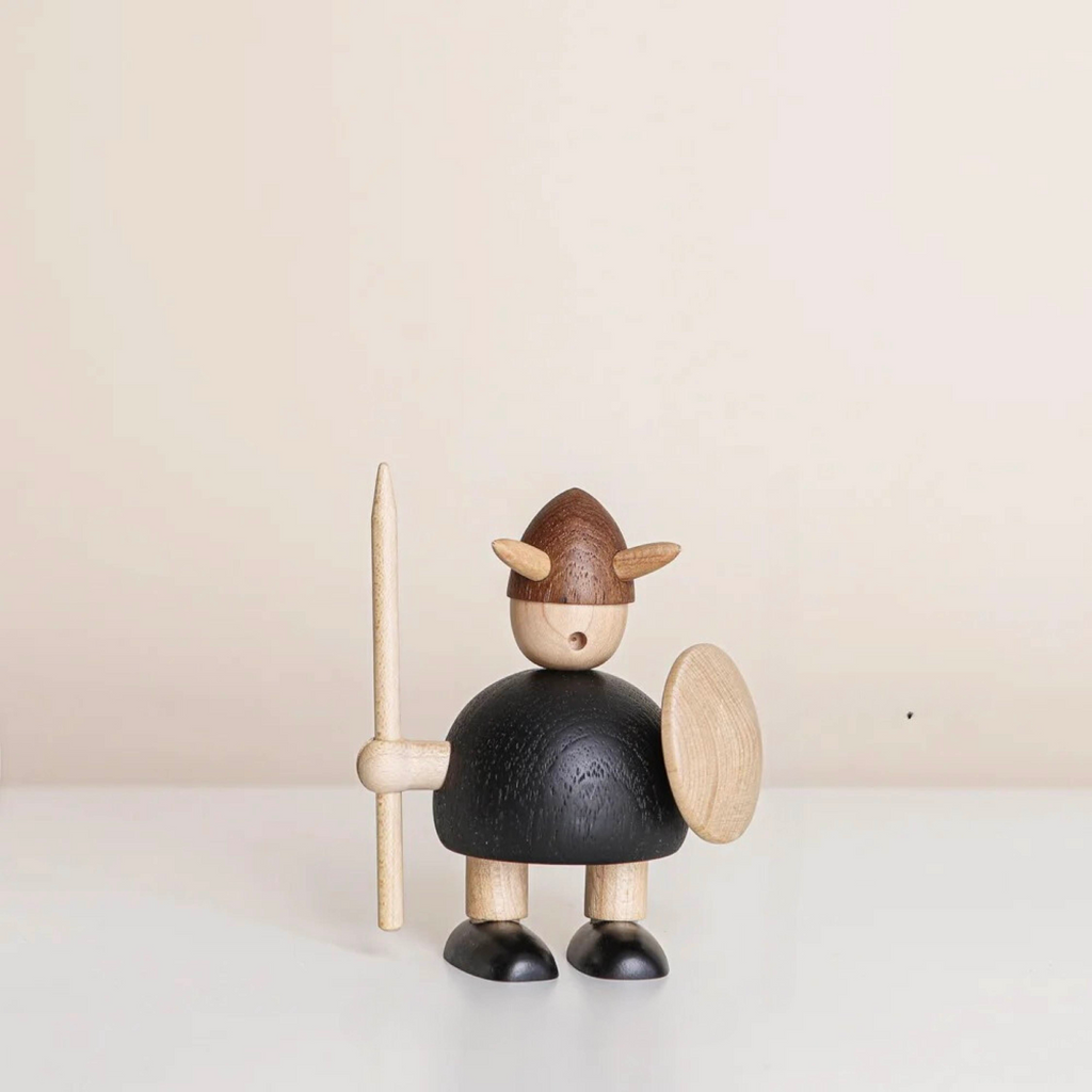 Wooden Viking figurine holding a spear and shield, carved from natural wood