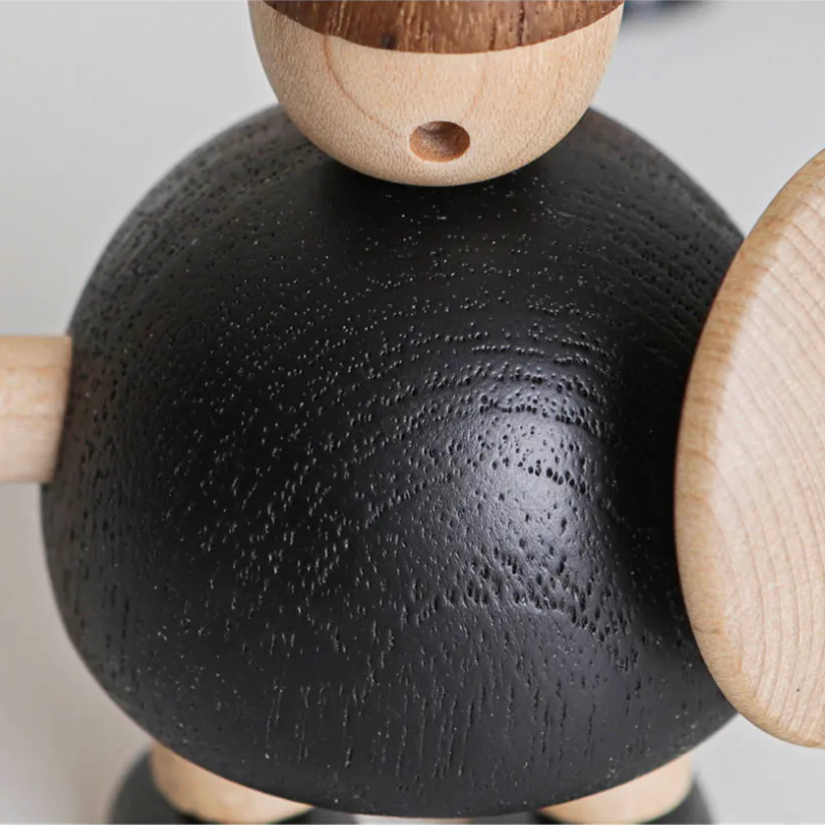 Close-up of wooden Viking figurine highlighting natural wood grain and carving details on body