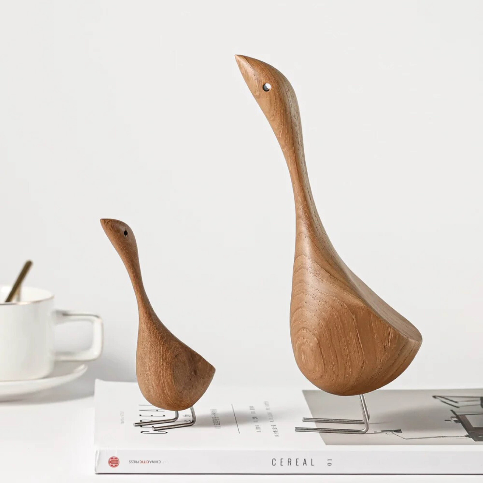 Handcrafted wooden goose figurines shown from a side angle