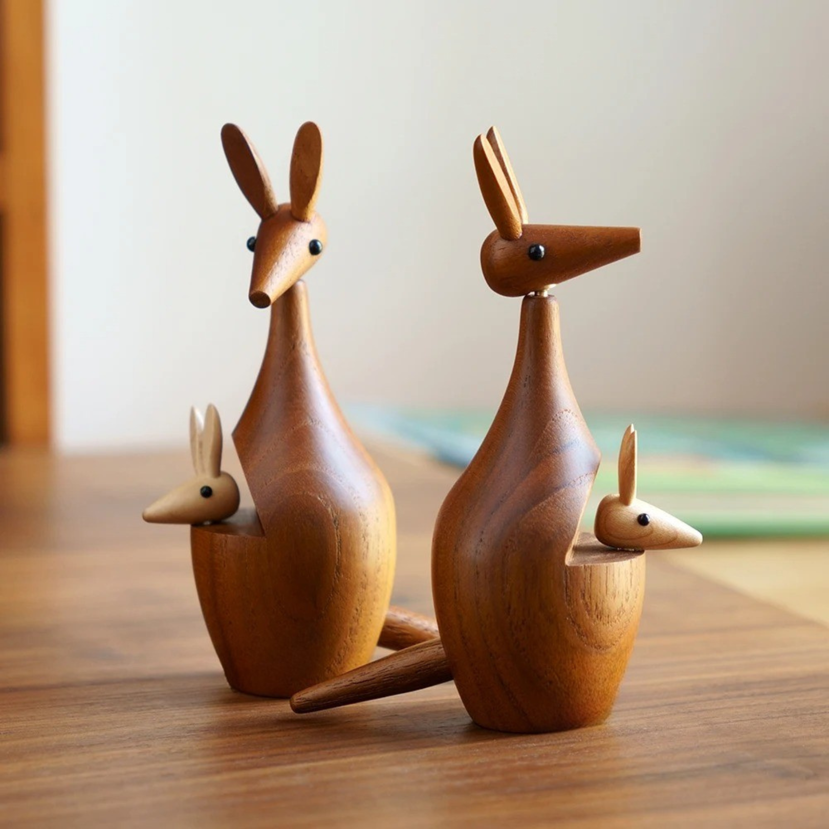 Two handcrafted wooden kangaroo decor pieces displayed side by side