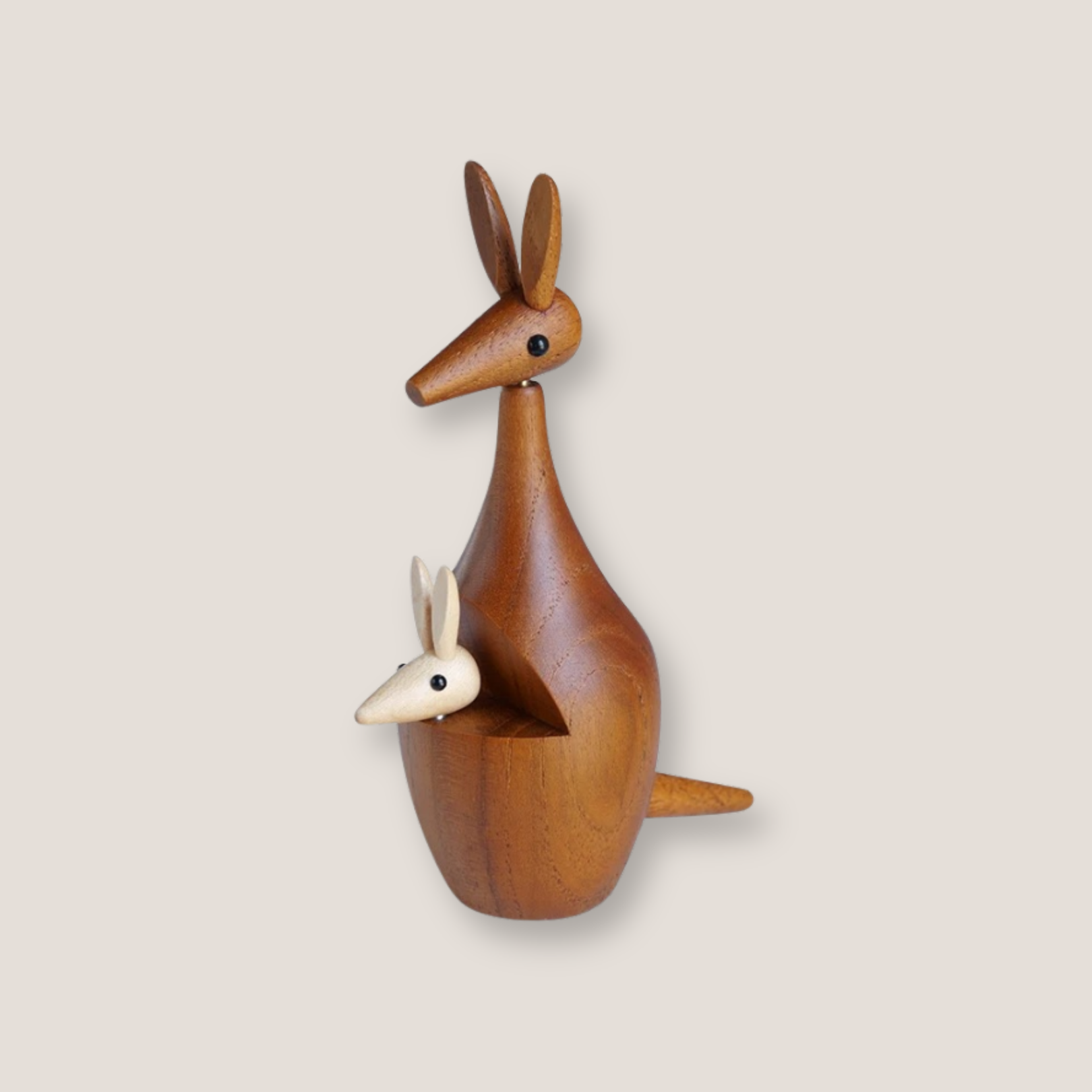 A wooden kangaroo decor with a mother kangaroo holding a baby kangaroo in her pouch.
