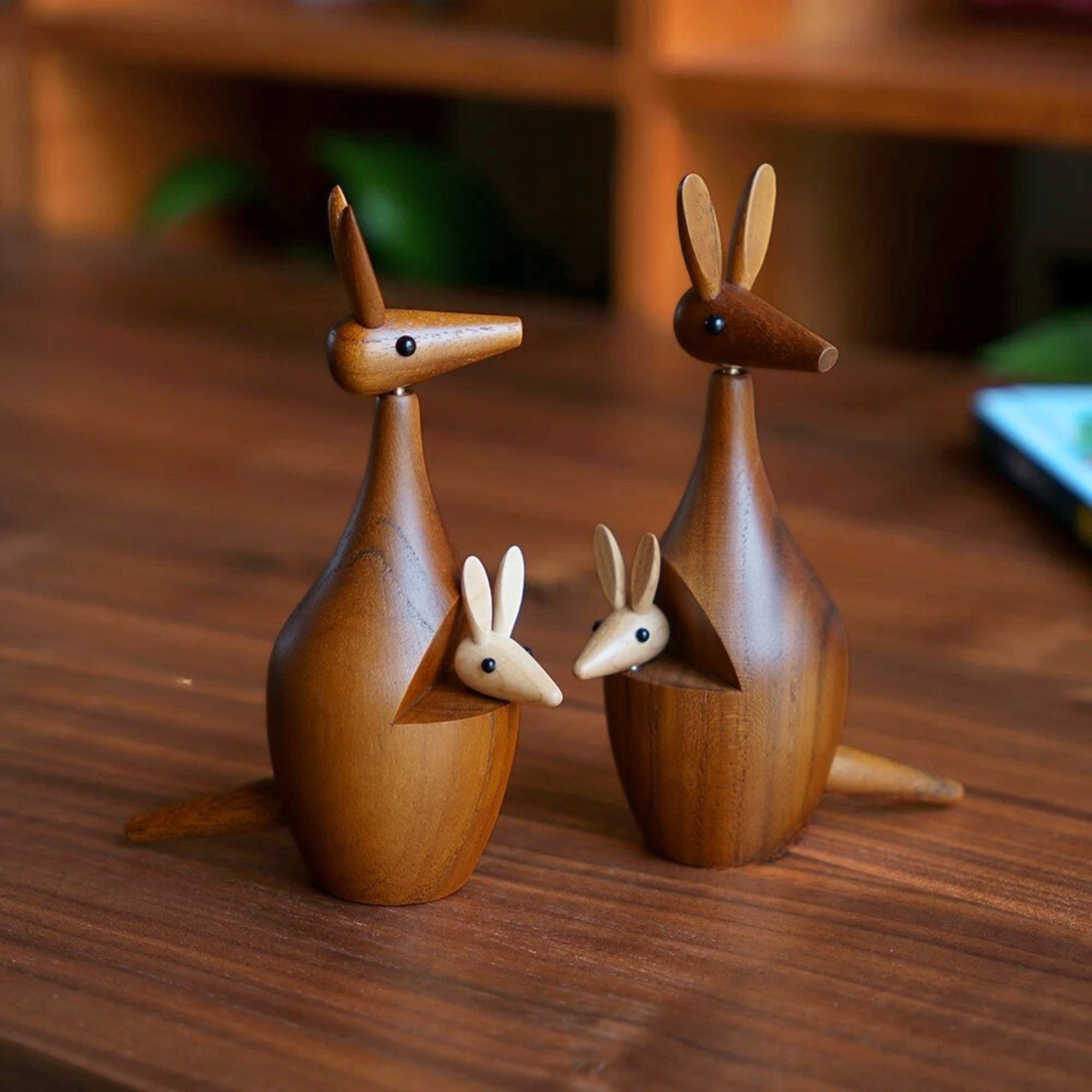 Two handcrafted wooden kangaroo decor pieces displayed side by side